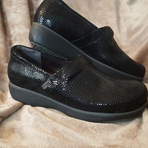 Black snakeskin clogs
